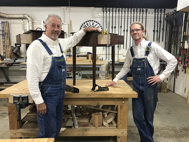 Staff photo by Emily Crisman / Chattanooga Woodworking Academy founder Bill Carney looks on as instructor Ryan Walker, a member of the school's first graduating class, works on a piece of furniture at the school's workshop on Main Street. The academy is holding a furniture show Nov. 1-10 at the Chattanooga Choo Choo.