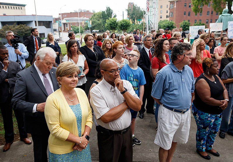 People watch a news conference outside the Hamilton County Courthouse which was held to support Hamilton County Mayor Jim Coppinger's fiscal year 2020 budget on Wednesday, June 5, 2019, in Chattanooga, Tenn. Mayor Coppinger later presented his budget, which calls for a tax increase for additional funding for schools, to the county commission.
