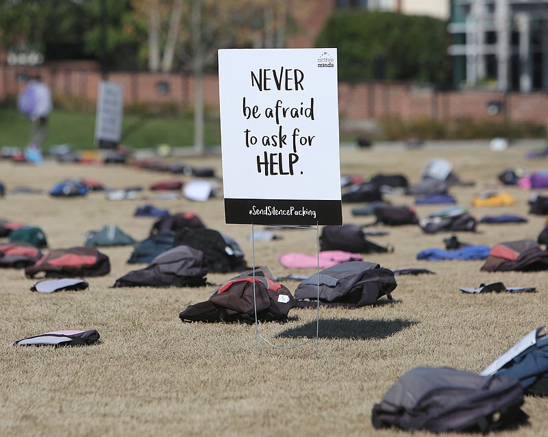 Signs and backpacks were scattered across the ground at the University of Tennessee at Chattanooga to bring awareness to mental health issues on Thursday, March 22, 2018 in Chattanooga, Tenn. Some backpacks included belongings of suicide victims and some contained letters with information about those college students.