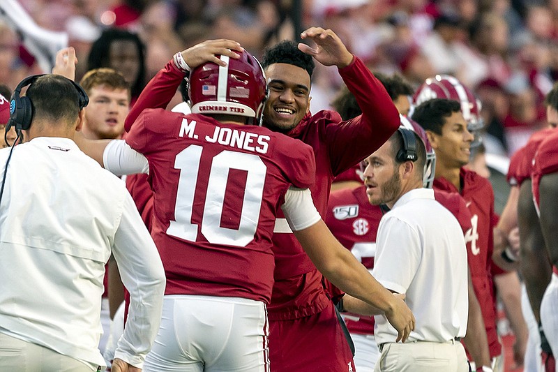 AP photo by Vasha Hunt / Injured Alabama quarterback Tua Tagovailoa hugs Mac Jones, who started in his place against Arkansas on Saturday, during the first half of the SEC West matchup in Tuscaloosa, Ala.