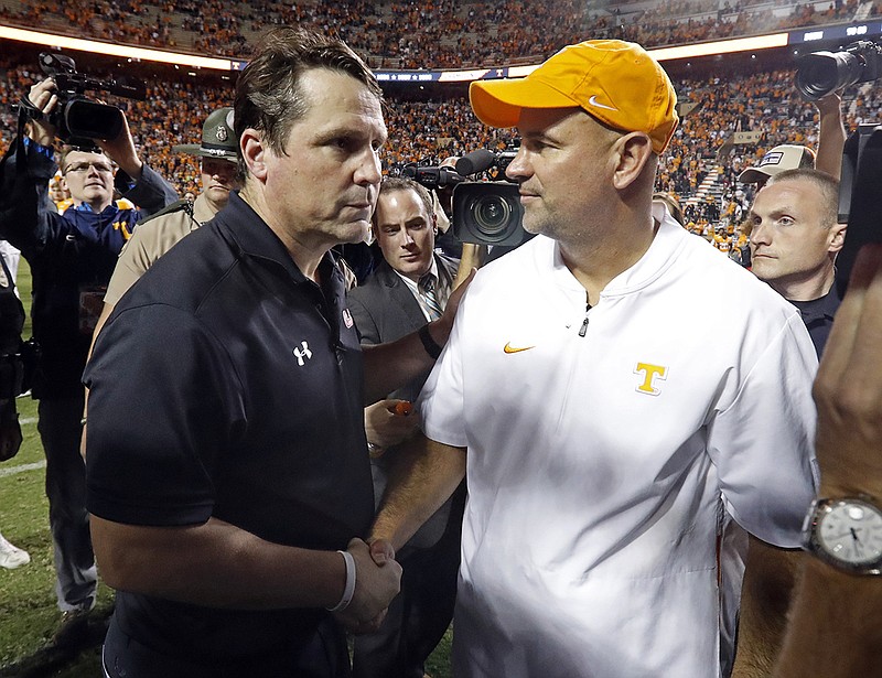 AP photo by Wade Payne / Tennessee coach Jeremy Pruitt, right, shakes hands with South Carolina coach Will Muschamp after Saturday's game at Neyland Stadium in Knoxville.