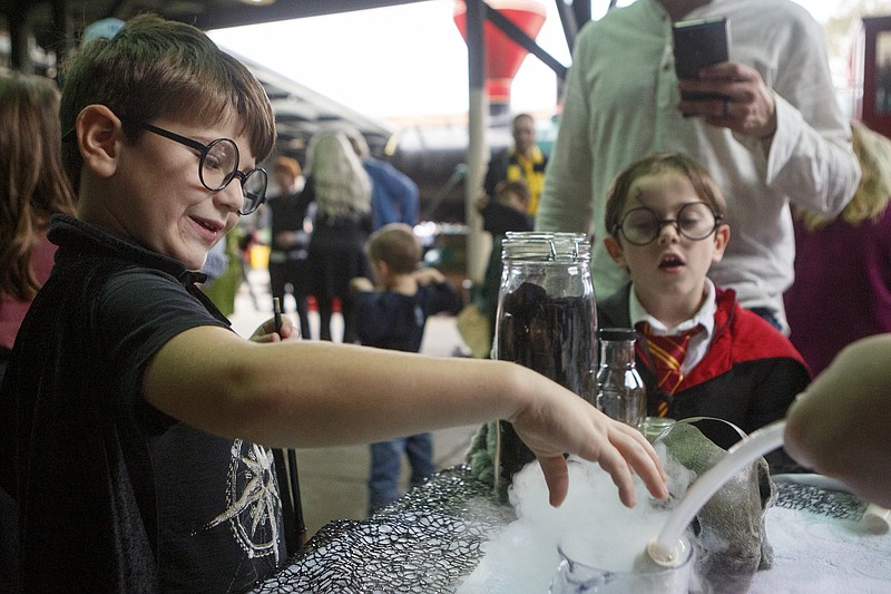Staff photo by C.B. Schmelter / Rhett Saggio checks out the Creative Discovery Museum's potions exhibit during the second annual Magic of Literacy event at the Chattanooga Choo Choo on Sunday, Oct. 27, 2019 in Chattanooga, Tenn. The Harry Potter-themed event is hosted by Moms for Social Justice to celebrate literacy and bring the community together.