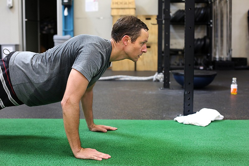 Staff photo by Erin O. Smith / Ben Frieberg does pushups at Sports Barn Tuesday, September 17, 2019 in Chattanooga, Tennessee.