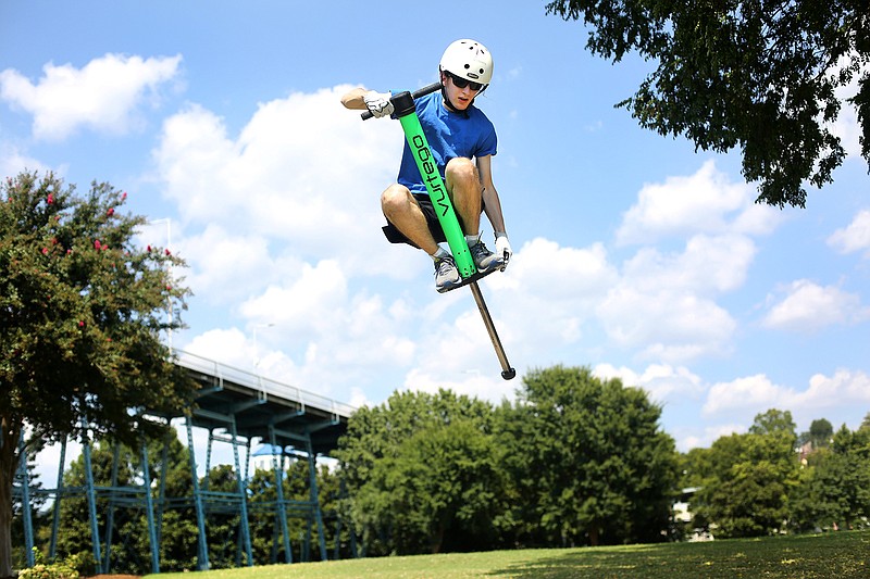 Staff photo by Erin O. Smith / Zachary Cross performs tricks on his pogo stick in Coolidge Park.