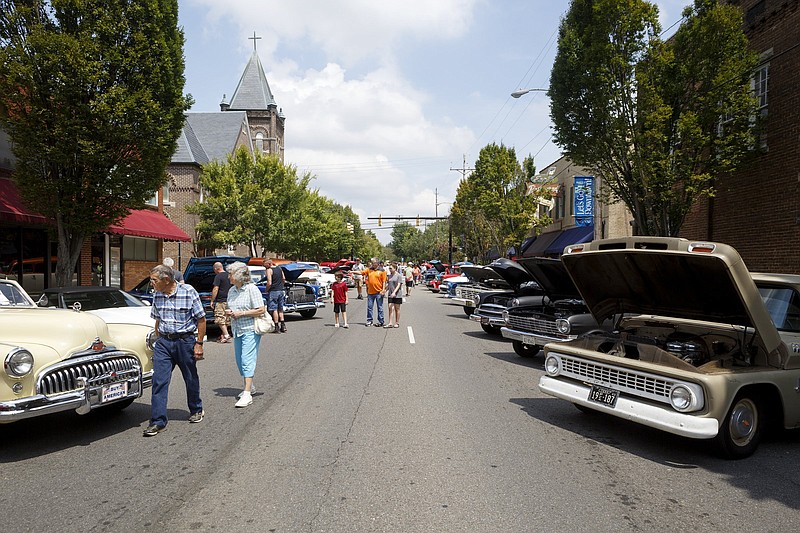 Staff photo by C.B. Schmelter / Visitors walk among the cars lined up along Broad Street during the MainStreet Cruise-In earlier this year in Cleveland, Tenn. The cruise-in is held on the fourth Saturday of each month, April through October, to draw visitors into Cleveland's downtown district.