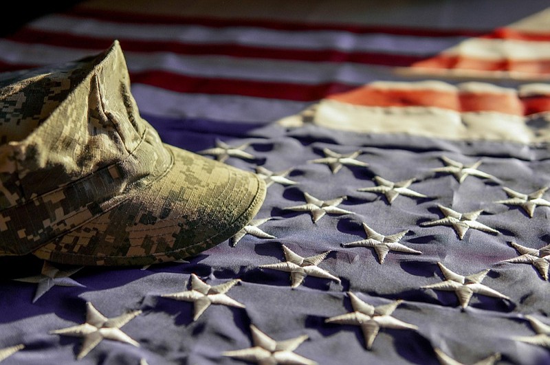 American flag and a cap of a soldier in the sunset light - veteran tile/american flag tile/military tile. (Getty)