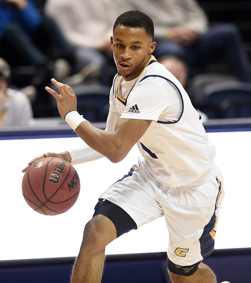 Maurice Commander (4) dribbles.  The University of Tennessee at Chattanooga Mocs hosted the Eastern Kentucky Colonels in men's basketball at McKenzie Arena on November 10, 2018.  / Staff photo by Robin Rudd