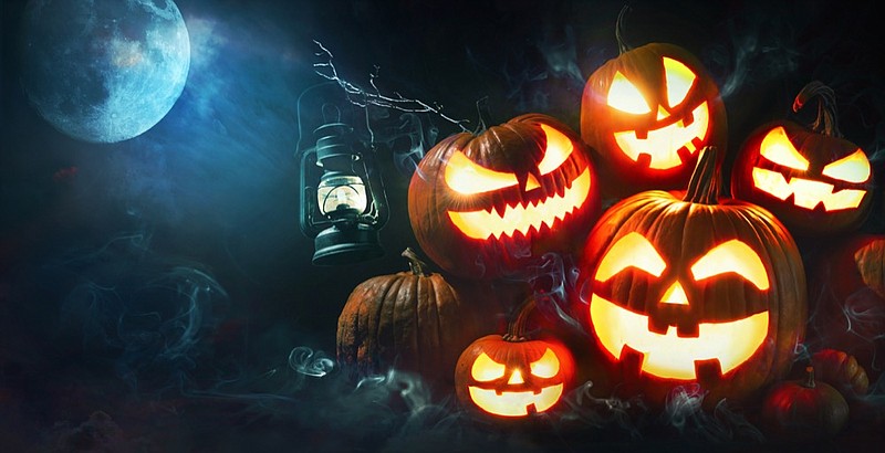 Halloween pumpkin head jack lantern with burning candles in scary deep night forest halloween tile jack o lantern tile / Getty Images
