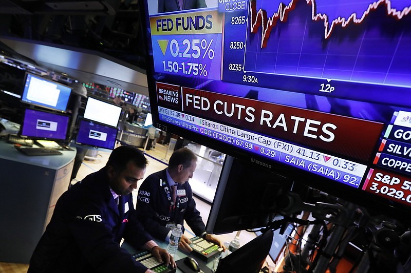 A television screen on the floor of the New York Stock Exchange shows the rate decision of the Federal Reserve, Wednesday, Oct. 30, 2019. The Federal Reserve has cut its benchmark interest rate for the third time this year to try to sustain the economic expansion in the face of global threats. (AP Photo/Richard Drew)