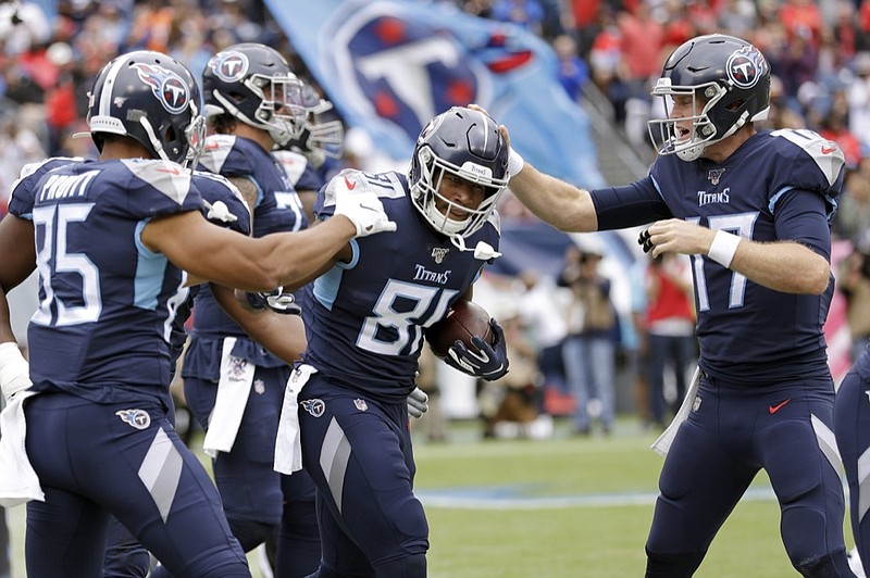 AP photo by James Kenney / Tennessee Titans tight end Jonnu Smith (81) is congratulated by tight end MyCole Pruitt (85) and quarterback Ryan Tannehill (17) after Smith scored a touchdown against the Tampa Bay Buccaneers this past Sunday in Nashville.
