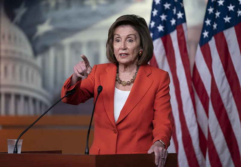 Speaker of the House Nancy Pelosi, D-California, talks to reporters just before the House vote on a resolution to formalize the impeachment investigation of President Donald Trump. / Associated Press photo by J. Scott Applewhite