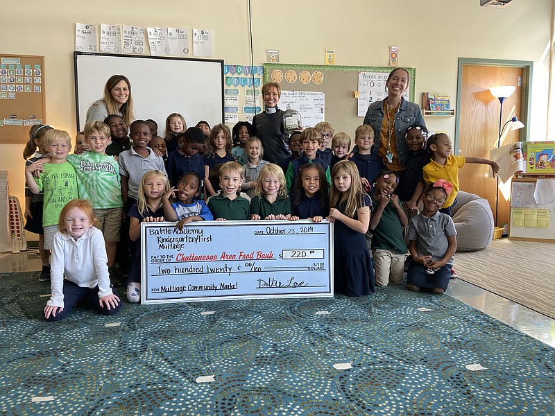 Contributed photo/Posing with Battle Academy Kindergarten's first-grade multiage class and their donation check are, in rear from left, teacher Dotti Love, Chattanooga Area Food Bank President & CEO Gina Crumbliss and teacher Ashleigh Snyder. 