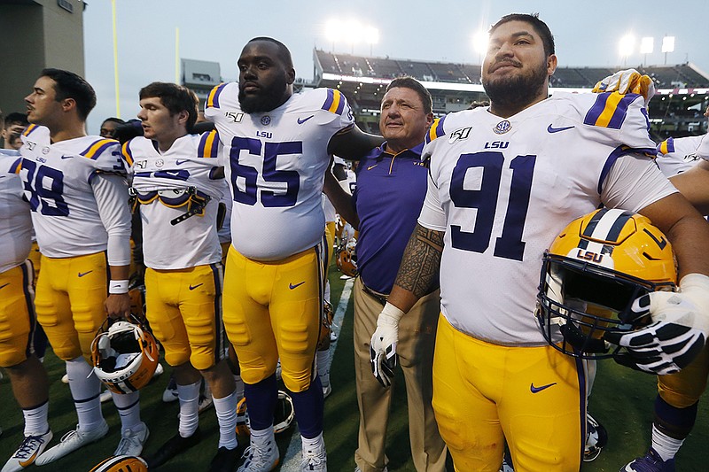AP photo by Rogelio V. Solis / LSU football coach Ed Orgeron joins his players as they sing their school song after a 36-13 win at Mississippi State on Oct. 19.