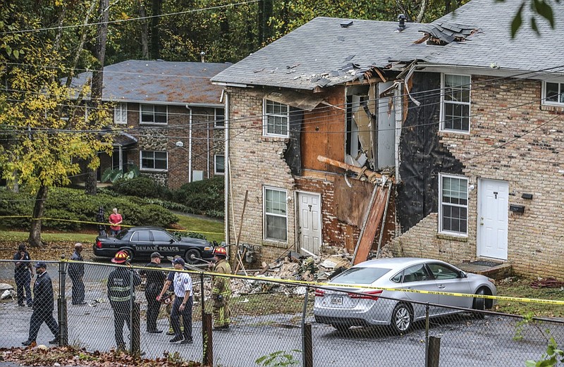 Fire officials look at the scene where an airplane crashed into an apartment complex, Wednesday, Oct. 30, 2019, in Atlanta. (John Spink/Atlanta Journal-Constitution via AP)


