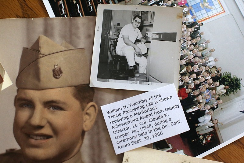 Staff photo by Erin O. Smith / Pictures of William Twombly from his military service and reunion photos sit out on the table during an interview with Twombly at his Collegedale, Tennessee, home Tuesday, October 15, 2019. Twombly was a conscientious objector who was a Whitecoat and served as a test subject for a cure to Q fever.