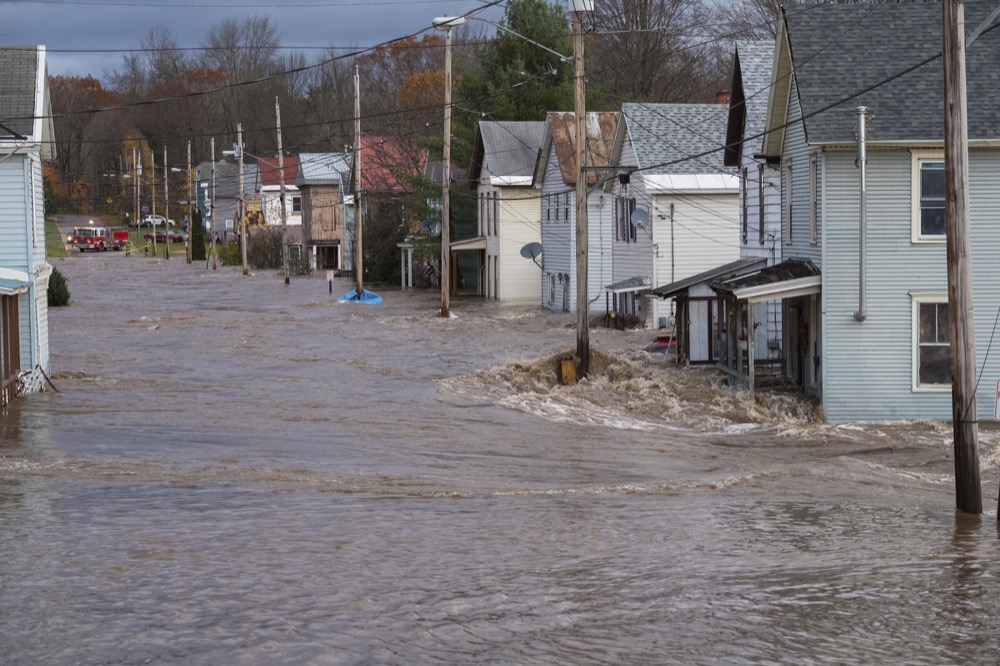 In this photo provided by the New York State Governor's Office, houses are flooded by rising waters of the East Canada Creek, Friday, Nov. 1, 2019 in Dolgeville, N.Y. Several hundred people were being evacuated in scattered areas around the state because of high waters. (Darren McGee/New York State Governor's Office via AP)