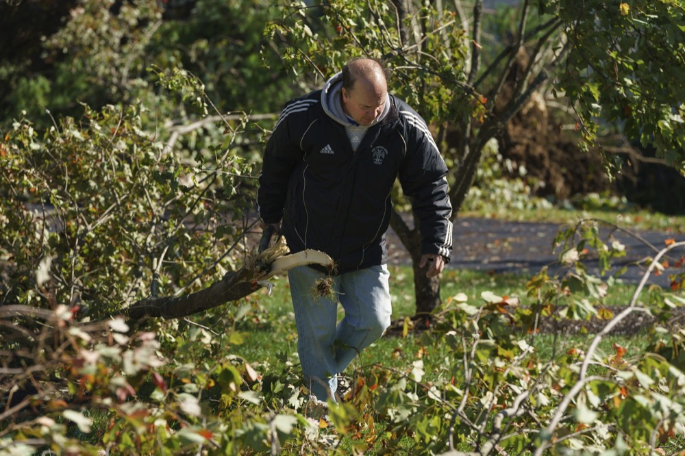 Gary Bevilacqua shown here beginning clean up fallen tree branches in the yard of his daughter's damaged home on Chelsea Court, in Thornbury Township, PA, where a severe storm hit the area last night, November 1, 2019.
