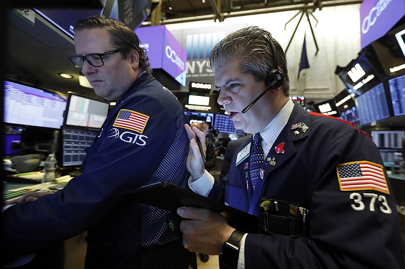 FILE - In this Tuesday, Oct. 29, 2019, file photo specialist Gregg Maloney, left, and trader John Panin work on the floor of the New York Stock Exchange. The U.S. stock market opens at 9:30 a.m. EDT on Friday, Nov. 1. (AP Photo/Richard Drew, File)