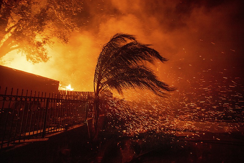 Strong, dry winds send embers flying as the Hillside Fire burns in San Bernardino, Calif., on Thursday, Oct. 31, 2019. The blaze, which ignited during red flag fire danger warnings, destroyed multiple residences. (AP Photo/Noah Berger)