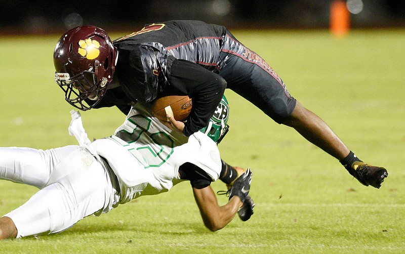 Staff Photo by Robin Rudd / East Hamilton's Chandler Foster (22) makes a open-field tackle of Howard's Eric Johnson during Friday night's game at Howard.