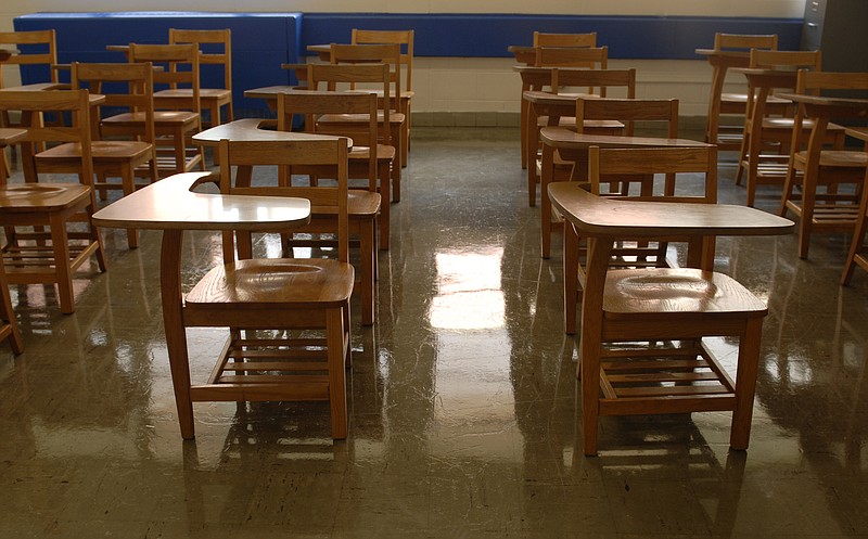 Staff file photo / Desks sit in an empty classroom at Red Bank High School in August 2012.