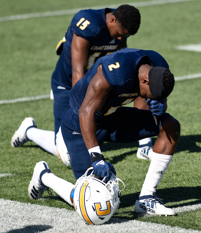 Staff Photo by Robin Rudd/ Mocs kanore McKinnon (2) and Kameron Brown (15) pray before the start of the game. The University of Tennessee at Chattanooga Mocs hosted the Furman Paladins in a Southern Conference football game at Finley Stadium on November 2, 2019.