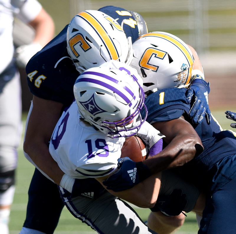 Staff Photo by Robin Rudd/ UTC's Ty Boeck (46) and Brandon Dowdell (1) stop Furman's Zach Peterson (19). The University of Tennessee at Chattanooga Mocs hosted the Furman Paladins in a Southern Conference football game at Finley Stadium on November 2, 2019.