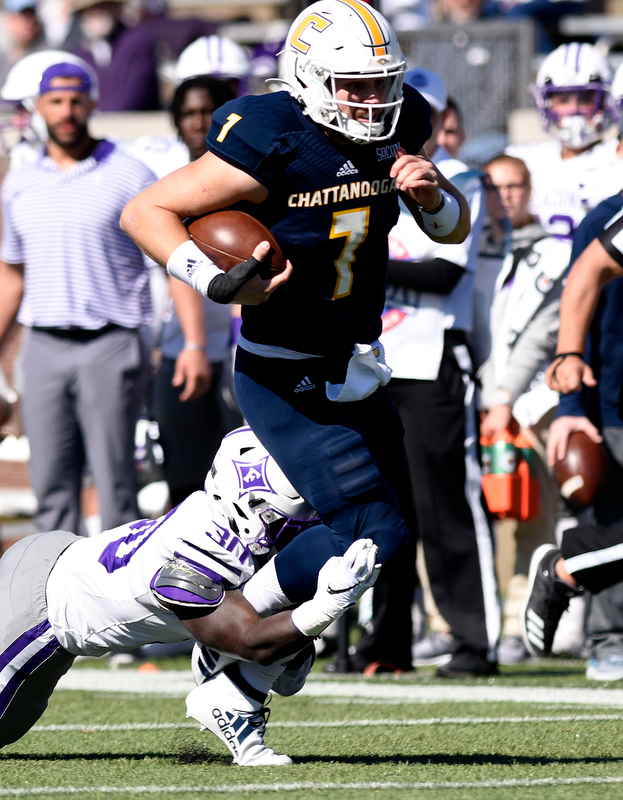 Staff Photo by Robin Rudd/ UTC's Nick Tiano (7) gets a first down before being tackled by Furman's Jordan Willis (30). The University of Tennessee at Chattanooga Mocs hosted the Furman Paladins in a Southern Conference football game at Finley Stadium on November 2, 2019.