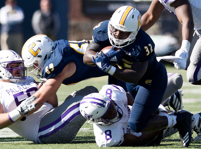 Staff Photo by Robin Rudd/ UTC's Ailym Ford (32) dives for yardage ager being hit by Furman's Bryan Okeh (8). The University of Tennessee at Chattanooga Mocs hosted the Furman Paladins in a Southern Conference football game at Finley Stadium on November 2, 2019.