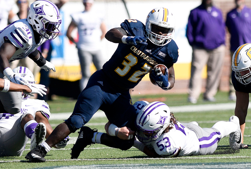 Staff Photo by Robin Rudd / UTC's Ailym Ford (32) tries to breaks free from Furman's Landon Lawrence (53) during last Saturday's Southern Conference matchup at Finley Stadium.