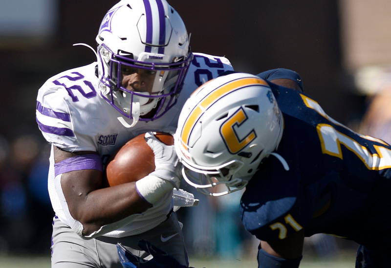 Staff Photo by Robin Rudd/ Furman's Devin Wynn (22) is hit by UTC's D.J. Jackson (21). The University of Tennessee at Chattanooga Mocs hosted the Furman Paladins in a Southern Conference football game at Finley Stadium on November 2, 2019.