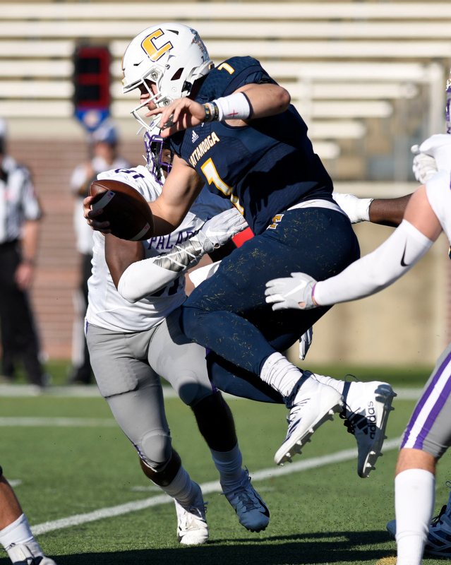 Staff Photo by Robin Rudd/ UTC's Nick Tiano (7) tries to escape the Furman defense, but is sacked by Adrian Hope (81). The University of Tennessee at Chattanooga Mocs hosted the Furman Paladins in a Southern Conference football game at Finley Stadium on November 2, 2019.