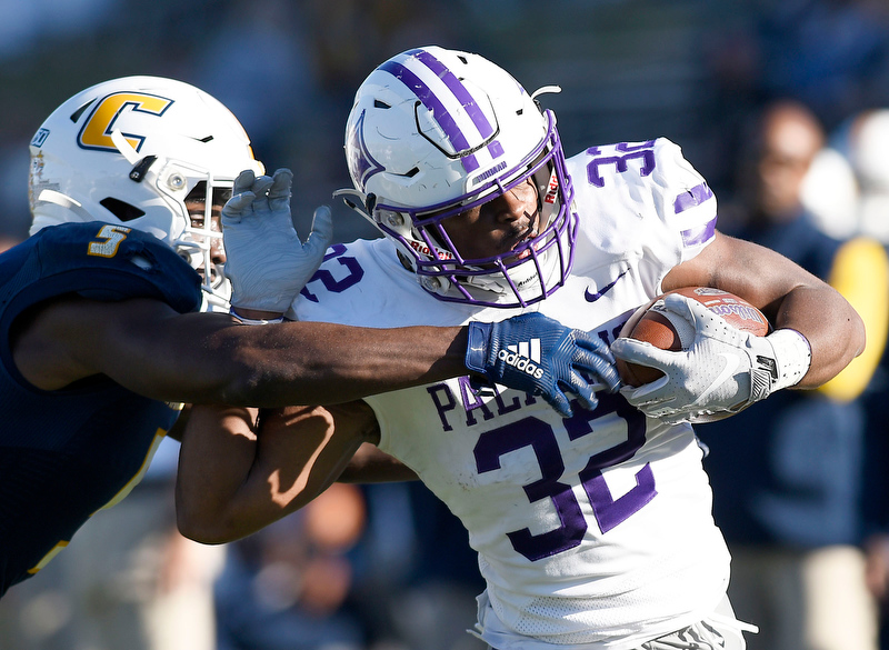 Staff Photo by Robin Rudd/ Furman's Devin Abrams (32) goes for a big gain before being forced out of bounds by UTC's CaMiron Smith (5). The University of Tennessee at Chattanooga Mocs hosted the Furman Paladins in a Southern Conference football game at Finley Stadium on November 2, 2019.