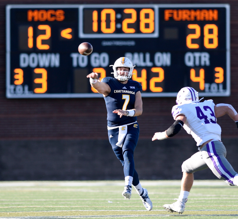 Staff Photo by Robin Rudd/ UTC Nick Tiano (7) fires a pass as he is chased by Furman's Braden Gilby (43). The University of Tennessee at Chattanooga Mocs hosted the Furman Paladins in a Southern Conference football game at Finley Stadium on November 2, 2019.