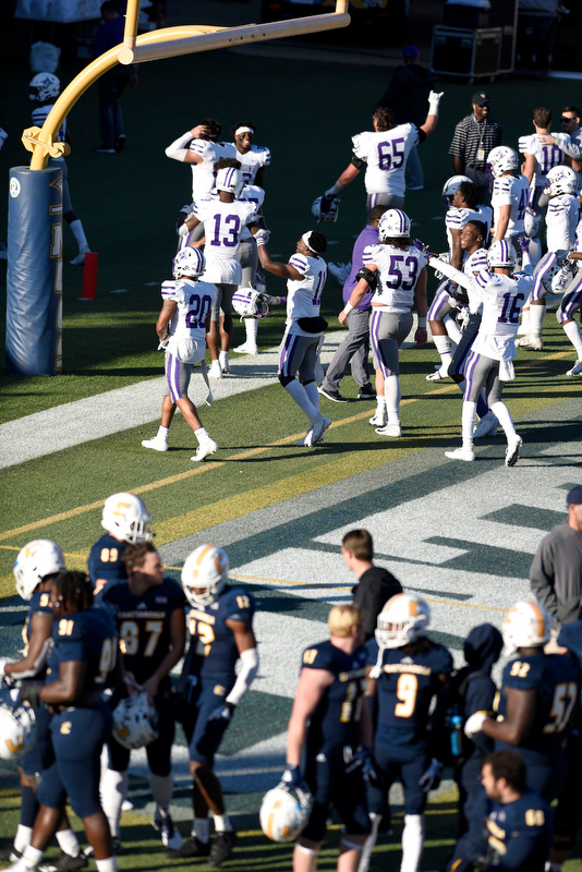 Staff Photo by Robin Rudd/ Furman celebrates as they leave the field after the defeating the Mocs 35 to 20. In the foregound the Mocs prepare to sing the Alma Mater. The University of Tennessee at Chattanooga Mocs hosted the Furman Paladins in a Southern Conference football game at Finley Stadium on November 2, 2019.