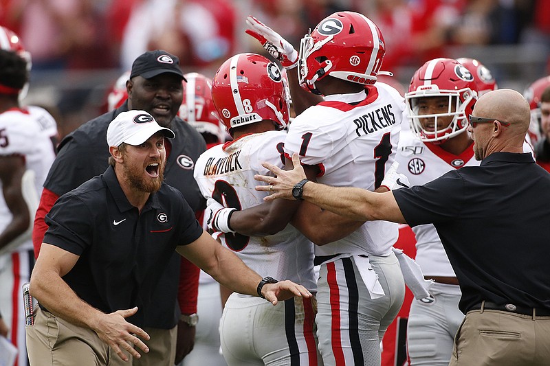 AP photo by Joshua L. Jones / Georgia wide receivers Dominick Blaylock and George Pickens celebrate after Blaylock caught a 3-yard touchdown pass from Jake Fromm in the second quarter of Saturday's game in Jacksonville, Fla.