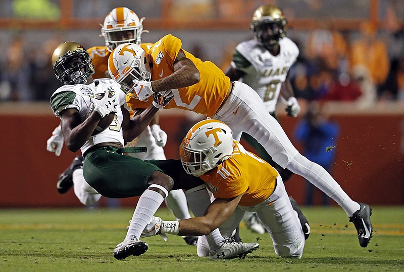 AP photo by Wade Payne / UAB wide receiver Myron Mitchell is tackled by Tennessee defensive back Alontae Taylor (2) and linebacker Henry To'o To'o (11) in the first half of Saturday night's game at Neyland Stadium in Knoxville.