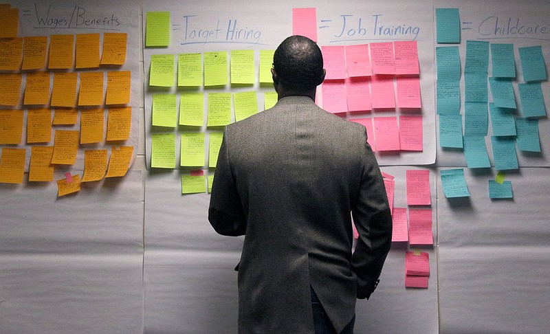Staff photo by Erin O. Smith / The Rev. Randy Jacks, the pastor at Miracle Missionary Baptist Church and a member of the Tubman Opportunity Steering Committee, checks out questions and ideas written down on sticky notes during the Harriet Tubman Site Town Hall Meeting held at Orchard Knob Missionary Baptist Church Saturday, November 2, 2019 in Chattanooga, Tennessee. The event was held to discuss the next steps for the Tubman site.
