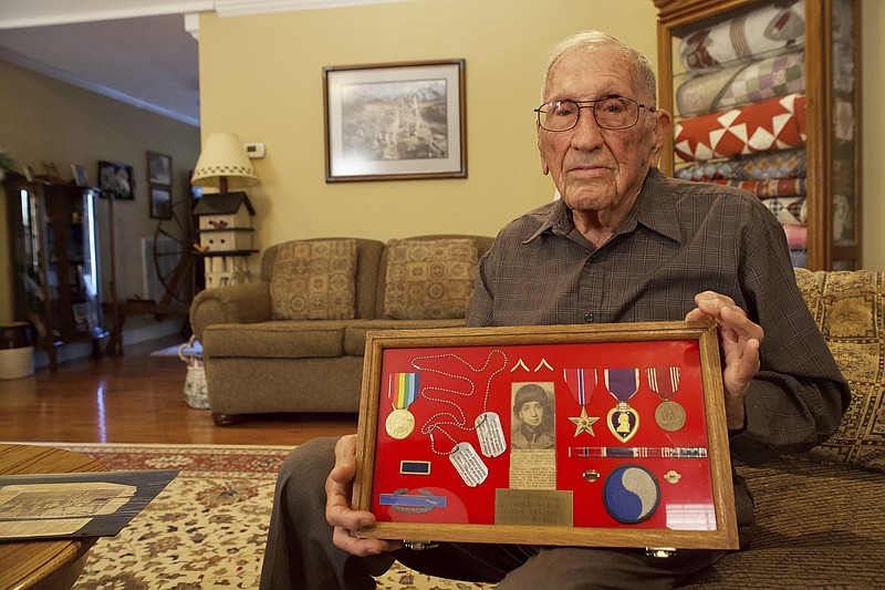 Staff photo by Wyatt Massey / James Yarbrough, 94, holds a case of his dog tags and military awards in his North Georgia home on Oct. 16.
