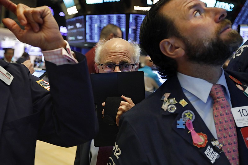 Trader Peter Tuchman, center, works on the floor of the New York Stock Exchange, Monday, Nov. 4, 2019. Stocks are opening higher on Wall Street, pushing major indexes toward more record highs. (AP Photo/Richard Drew)