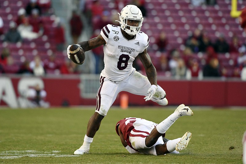 AP photo by Michael Woods / Mississippi State running back Kylin Hill avoids Arkansas defender Andrew Parker on Nov. 2, 2019, in Fayetteville, Ark.