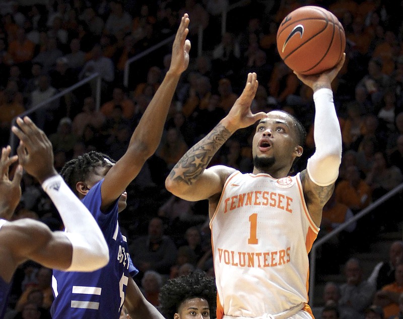 Tennessee's Lamonte Turner (1) shoots a short left handed shot in the lane defended by UNC Asheville's Trent Stephney during an NCAA college basketball game Tuesday, Nov. 5, 2019, in Knoxville, Tenn. (Tom Sherlin/The Daily Times via AP)