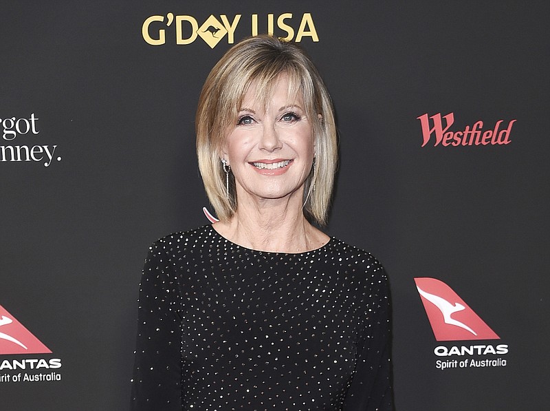 In this Jan. 27, 2018 file photo, Olivia Newton-John attends the 2018 G'Day USA Los Angeles Gala at the InterContinental Hotel Los Angeles. Two collectors said you're the one that I want to Newton-John's iconic "Grease" leather jacket and skintight pants at an auction in Beverly Hills, Saturday, Nov. 2, 2019. Julien's Auctions says the combined ensemble, which Newton-John's character Sandy wears in the closing number of the 1978 film, fetched $405,700 total. The leather jacket sold for $243,200 and the pants, which Newton-John famously had to be sewn into, went for $162,500. (Photo by Richard Shotwell/Invision/AP, File)
