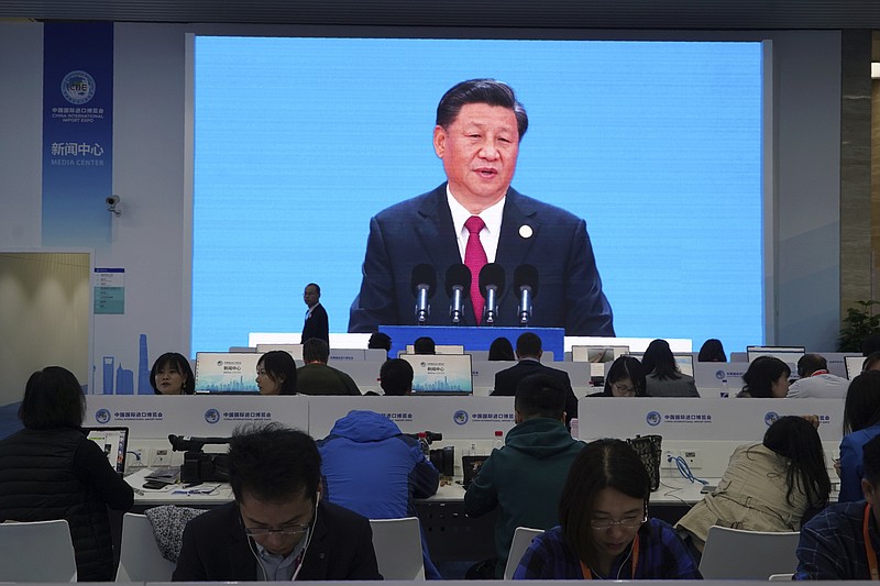 Chinese President Xi Jinping is seen on a live broadcast speaking at the media center during the opening of the China International Import Expo in Shanghai, Tuesday, Nov. 5, 2019. Xi promised Tuesday to open China wider to imports and foreign investment at the start of a high-profile trade fair meant to rebrand the country as a global customer and warned against trade protectionism. (AP Photo/Dake Kang)