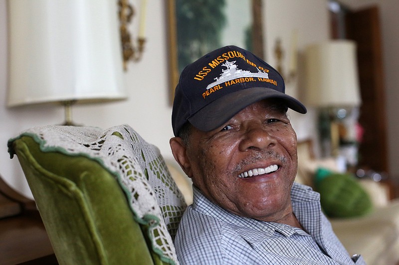 Staff photo by Erin O. Smith / World War II Navy veteran James Elligan Sr., 93, holds a photo of himself in uniform as he poses for a photo at his Chattanooga, Tennessee, home Monday, October 8, 2019. Elligan Sr. joined the military in 1943 and served overseas in the South Pacific.