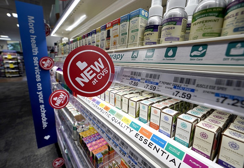 FILE - In this May 30, 2019, file photo, signs advertise new products available inside a CVS store with the new HealthHUB in Spring, Texas. CVS Health reports financial results Wednesday, Nov. 6. (AP Photo/David J. Phillip, File)
