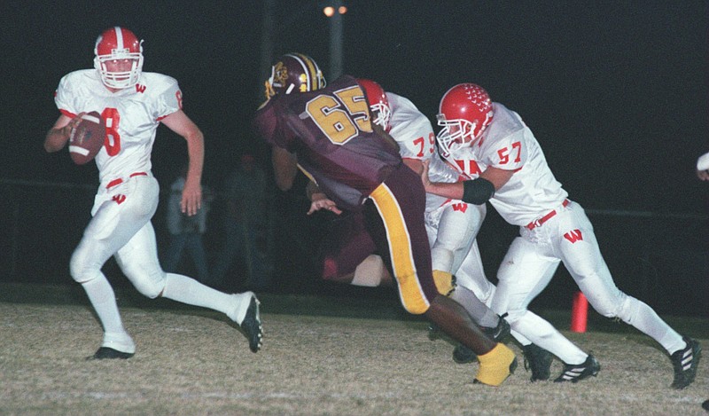 In this 2000 staff file photo, Westmoreland quarterback Derrick Gregory (8) is pursued by Tyner guard Demonte Bolden (65), who is blocked by Cody Brummett (75) and Anthony Braswell (57).