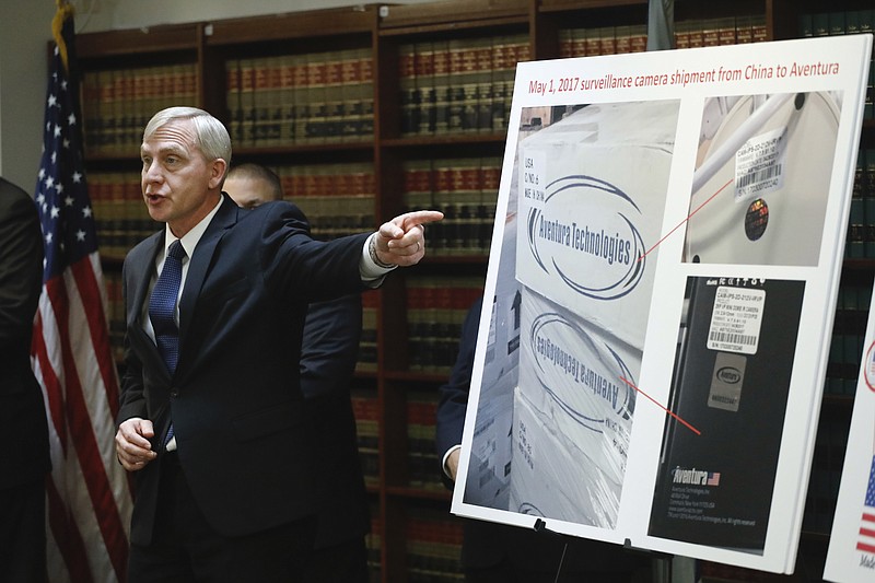 U.S. Attorney Richard P. Donoghue announces charges against Aventura Technologies, Thursday, Nov. 7, 2019, in the Brooklyn borough of New York. The New York company has been charged with illegally importing and selling Chinese-made surveillance and security equipment to U.S. government agencies and private customers. (AP Photo/Mark Lennihan)