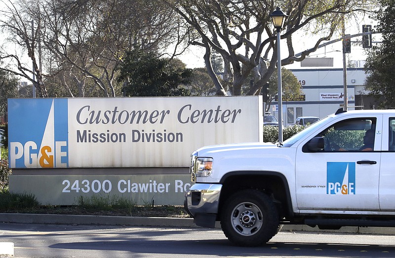 FILE- In this Jan. 23, 2019, file photo a Pacific Gas & Electric truck enters their customer center in Hayward, Calif. Pacific Gas & Electric Co. on Thursday, Nov. 7, reported a third-quarter loss of $1.62 billion, after reporting a profit in the same period a year earlier. (AP Photo/Ben Margot, File)