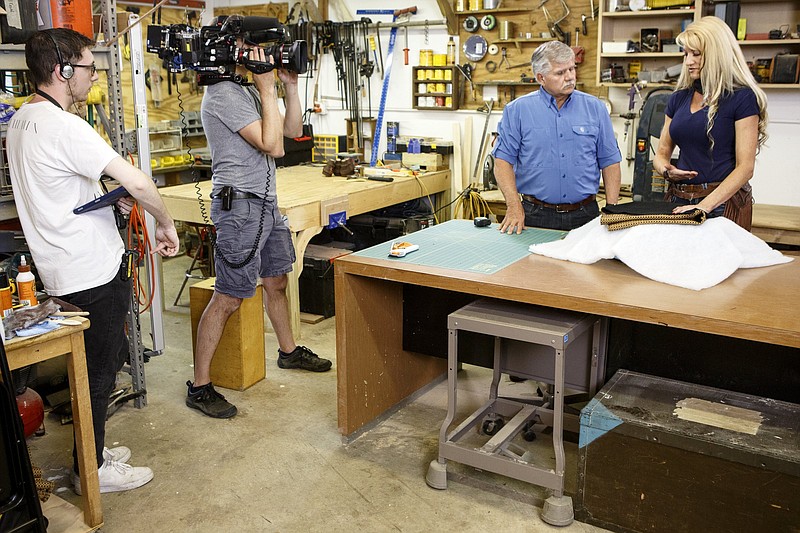 Staff photo by C.B. Schmelter / General Contractor Tom Silva, second from right, and Women Repair Zone instructor Belinda Harford work on making an upholstered footstool while filming an episode of "Ask This Old House" at a workshop off of Amnicola Highway on Tuesday, April 30, 2019 in Chattanooga, Tenn.